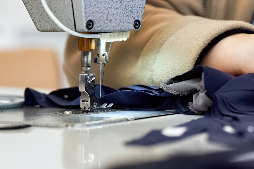 woman-working-sewing-machine-with-blue-fabric_1268-14714.jpg